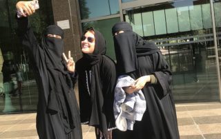 TEI’s Jennifer Wesselhoff (center) poses in the Kingdom of Saudi Arabia with two Saudi Arabian friends.